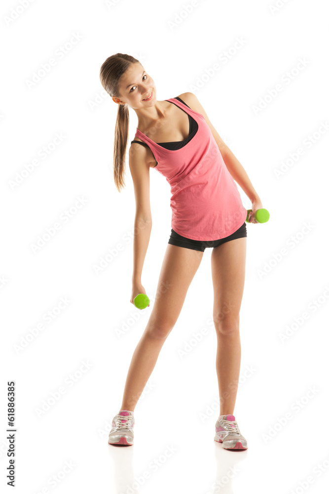 Athletic woman pumping up muscles with dumbbells Athletic woman pumping up muscles with dumbbells