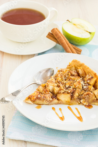 Slice of delicious fresh baked apple pie on a wooden surface