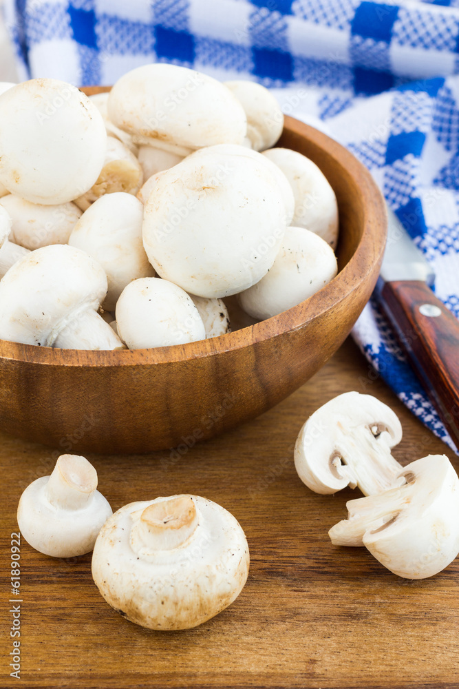Fresh mushrooms in a cup on a wooden surface Fresh mushrooms in a cup on a wooden surface