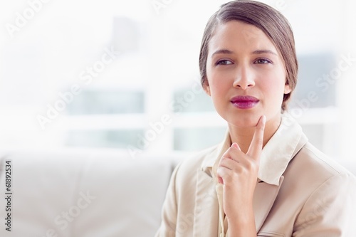 Thinking businesswoman sitting on sofa