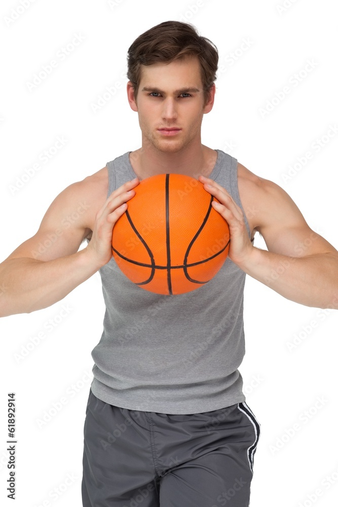 Fit man holding basketball about to throw to camera