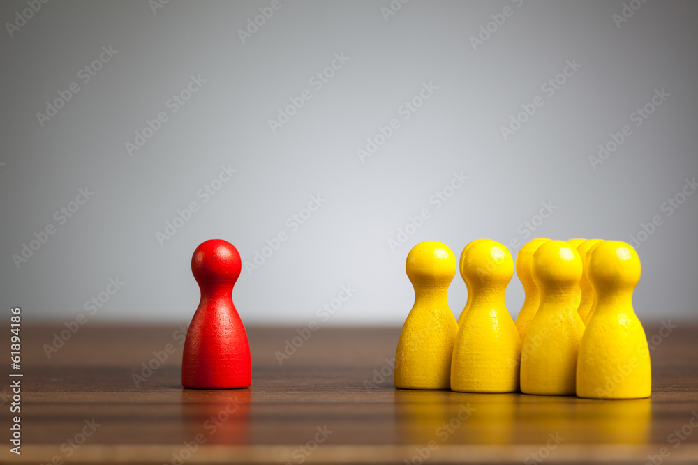 Red pawn figure against united yellow, isolation, confrontation,