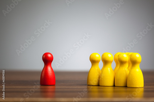 Obraz na płótnie Red pawn figure against united yellow, isolation, confrontation, w salonie