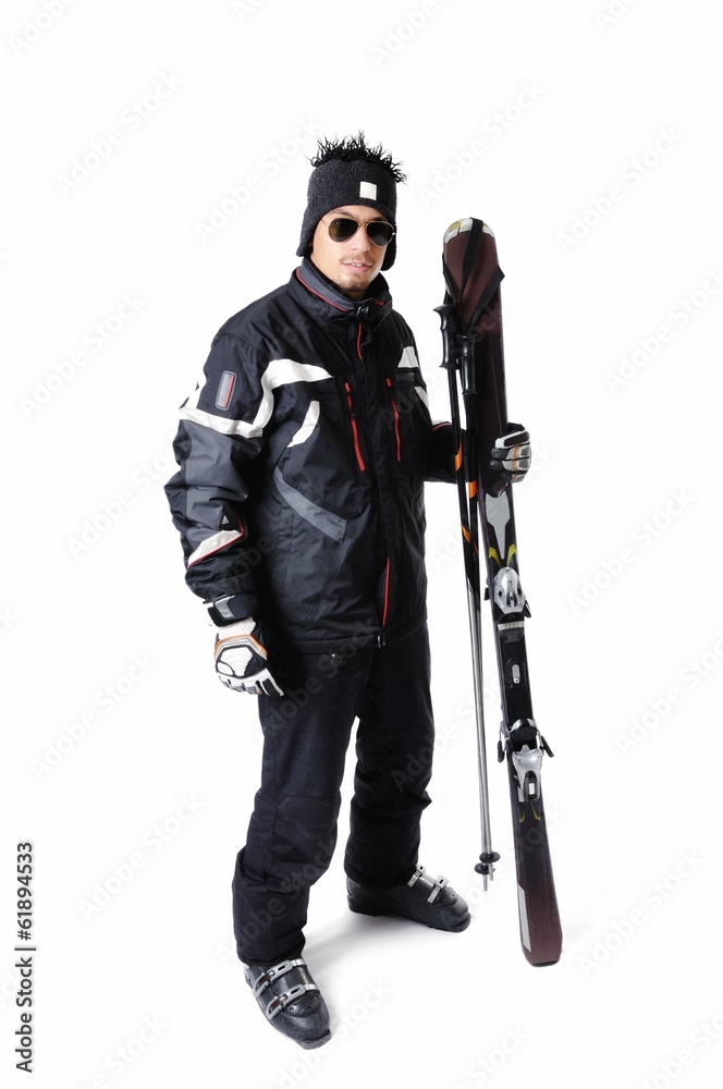 One male skier posing with full equipment on a white background One male skier posing with full equipment on a white background