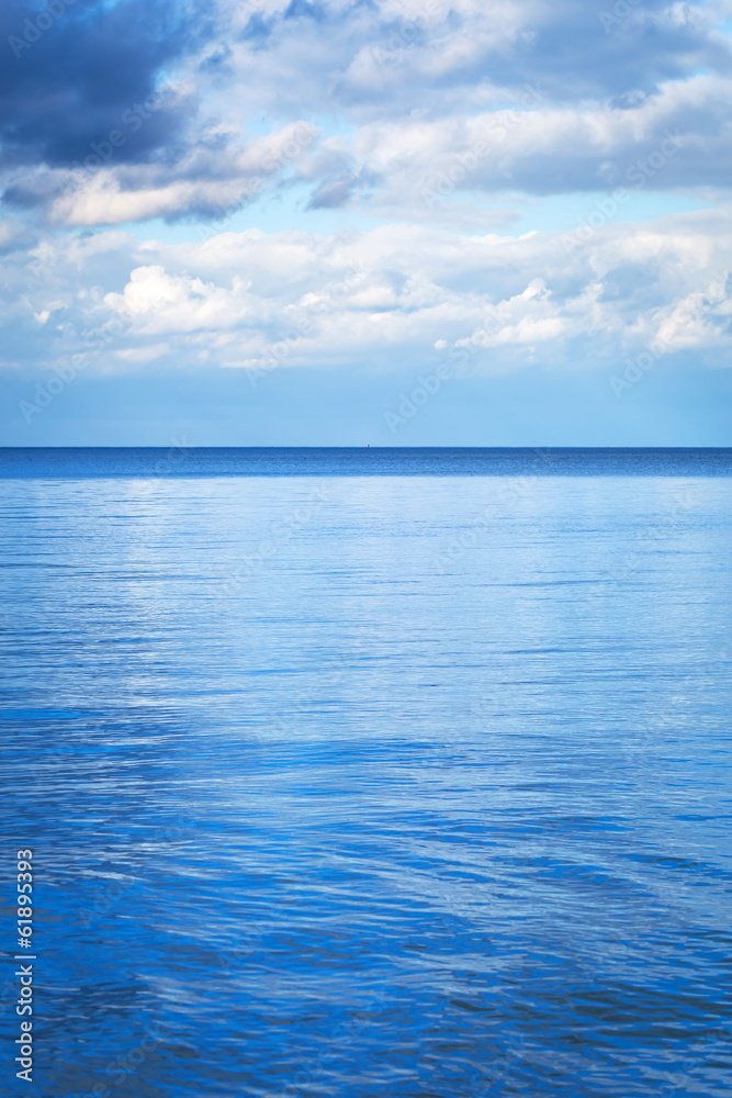 Obraz premium Calm Baltic sea with reflected blue sky