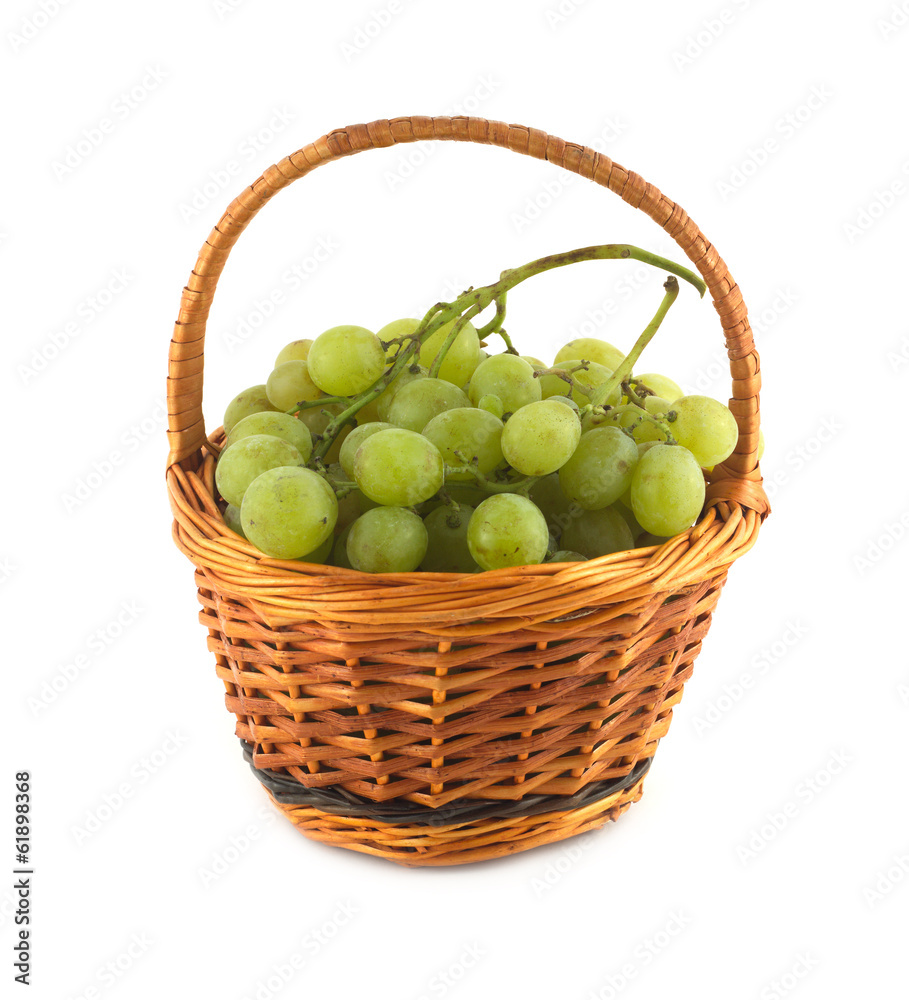 Ripe grape bunch in wicker basket isolated close up Ripe grape bunch in wicker basket isolated close up