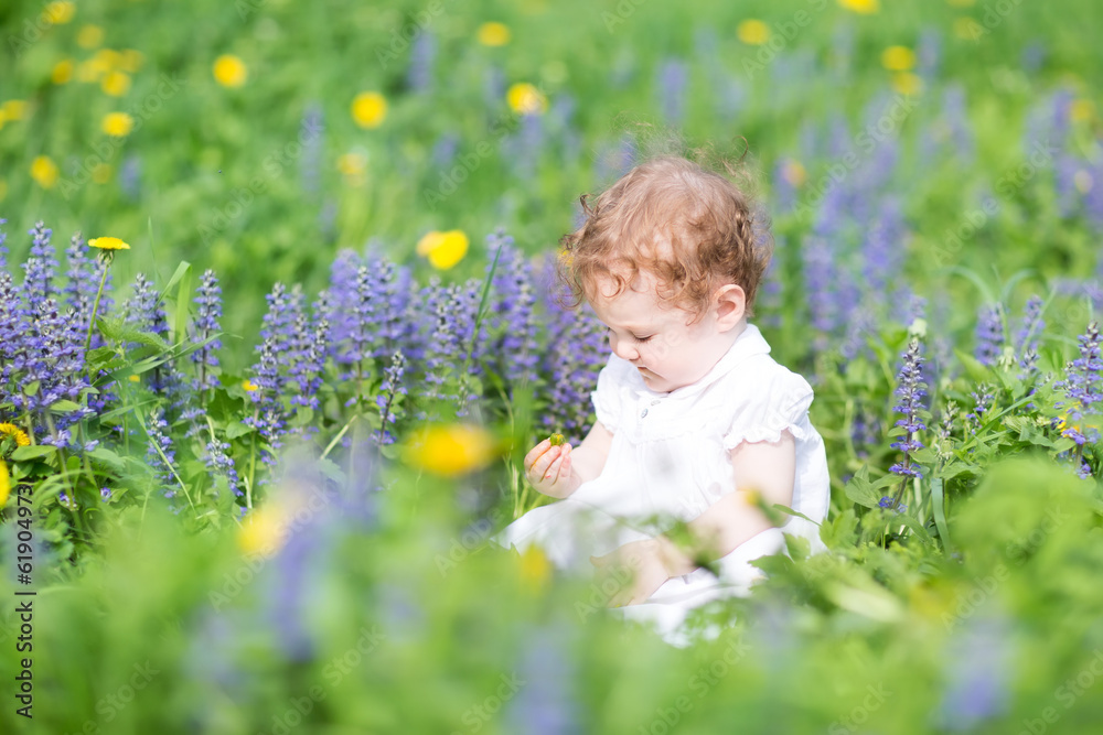 Funny baby girl playing in a garden Funny baby girl playing in a garden
