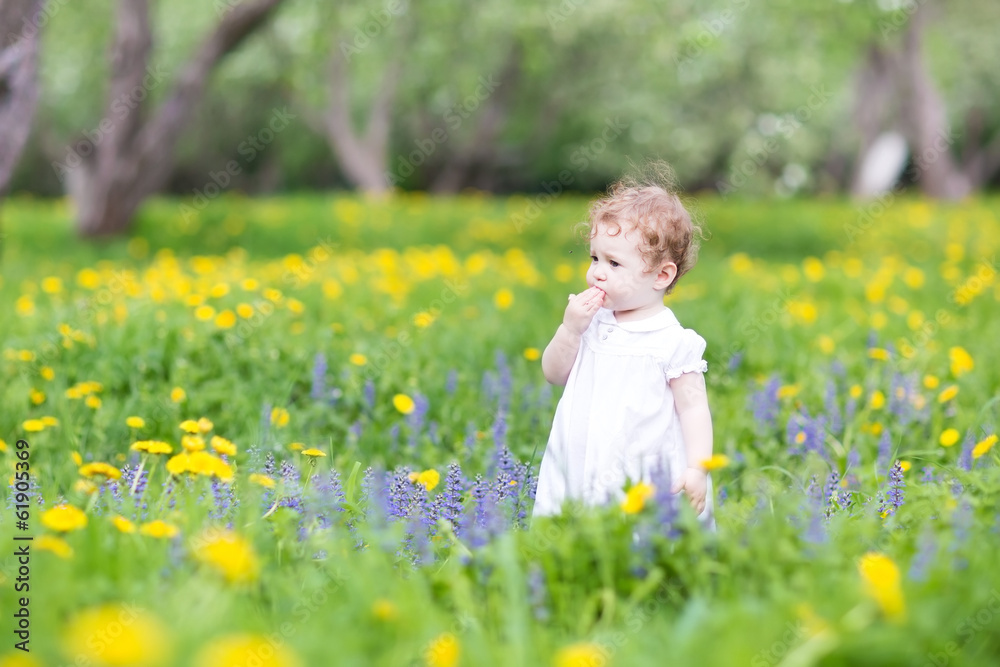 Cute little girl playing in a beautiful garden Cute little girl playing in a beautiful garden