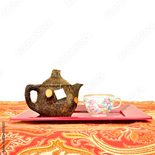 rustic teapot and cup isolated photo