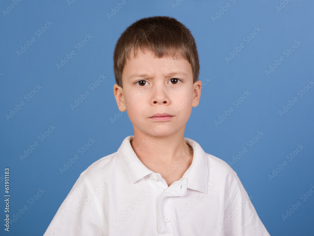 serious boy portrait on blue serious boy portrait on blue