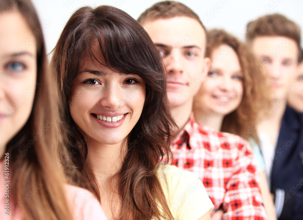 Young woman standing in front of young people standing in a row Young woman standing in front of young people standing in a row