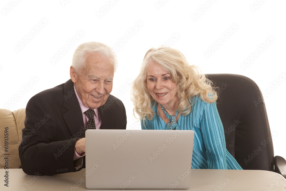 elderly couple laptop both smile