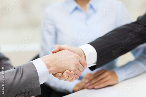 two businessmen shaking hands in office