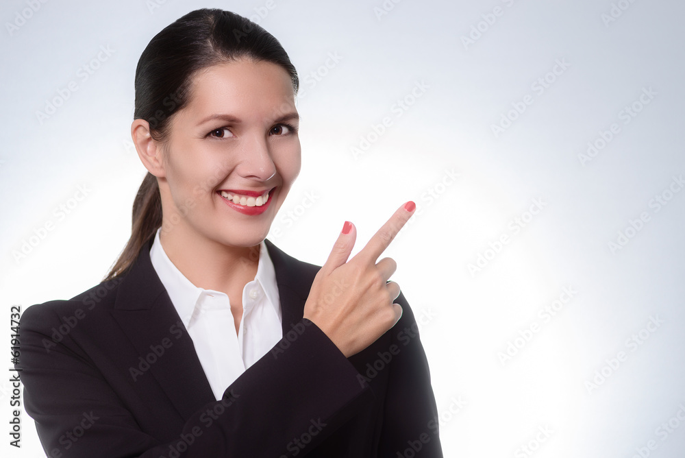 Beautiful friendly manageress pointing to copy space Beautiful friendly manageress pointing to copy space