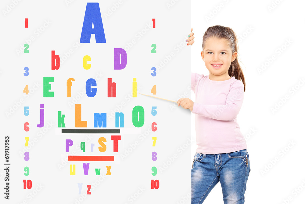 Young child pointing on colorful eyesight test with wooden stick Young child pointing on colorful eyesight test with wooden stick