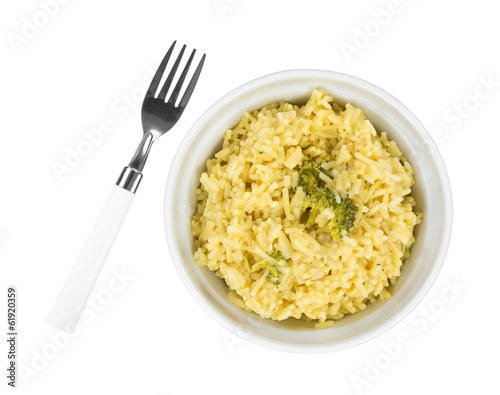 Cooked broccoli rice in bowl with fork