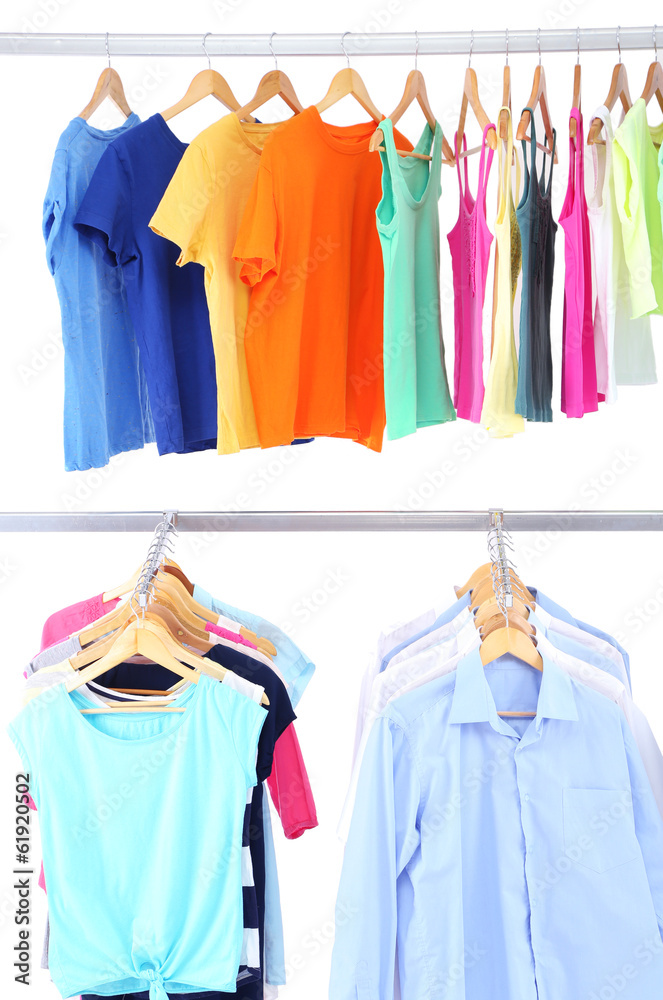 Different clothes on hangers, on gray background Different clothes on hangers, on gray background