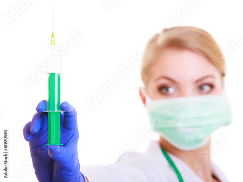 Woman in mask and lab coat. Doctor nurse with syringe.