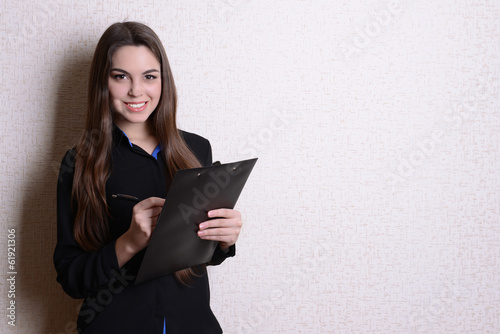 Portrait of businesswoman near wall