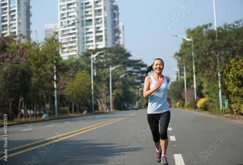 fitness woman running at city street
