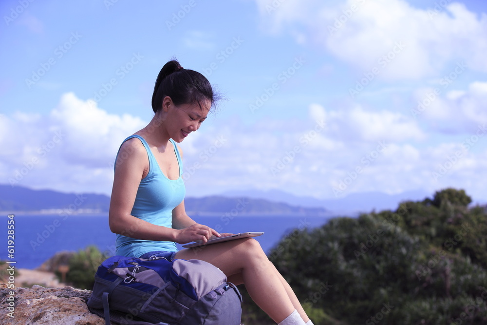 woman hiker seaside use digital tablet 