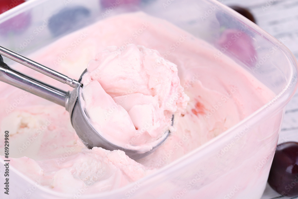 Ice cream in container and ice cream spoon Ice cream in container and ice cream spoon