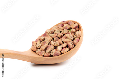 Wooden spoon with pistachios.