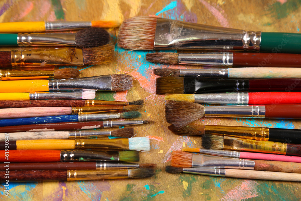 Fototapeta premium Brushes on multicolor wooden background