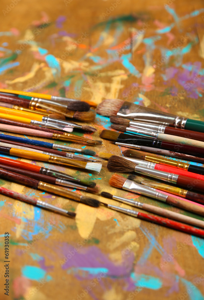 Brushes on multicolor  wooden background