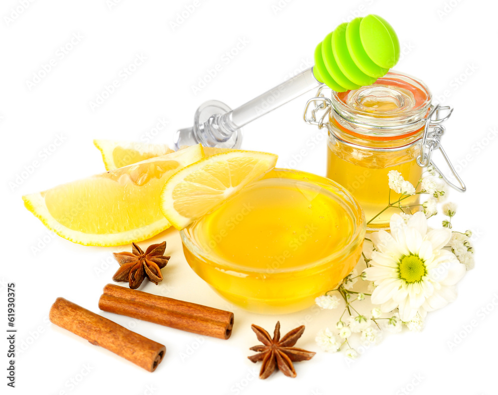 Sweet honey with lemon and cinnamon isolated on white Sweet honey with lemon and cinnamon isolated on white