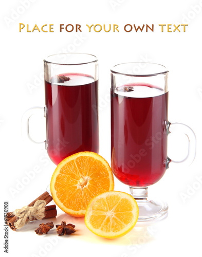 Mulled wine with oranges and spices isolated on white