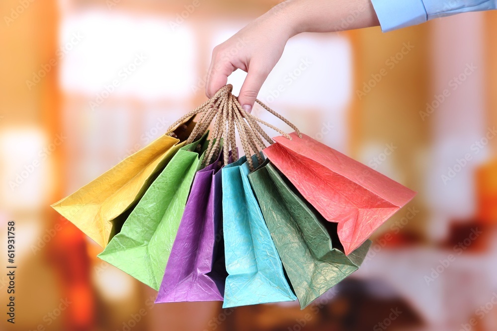 Young woman holding colorful shopping bags in  her hand,