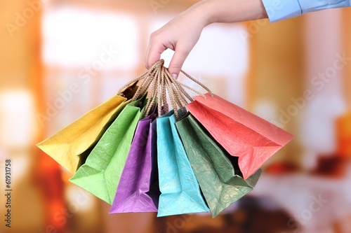 Young woman holding colorful shopping bags in her hand,