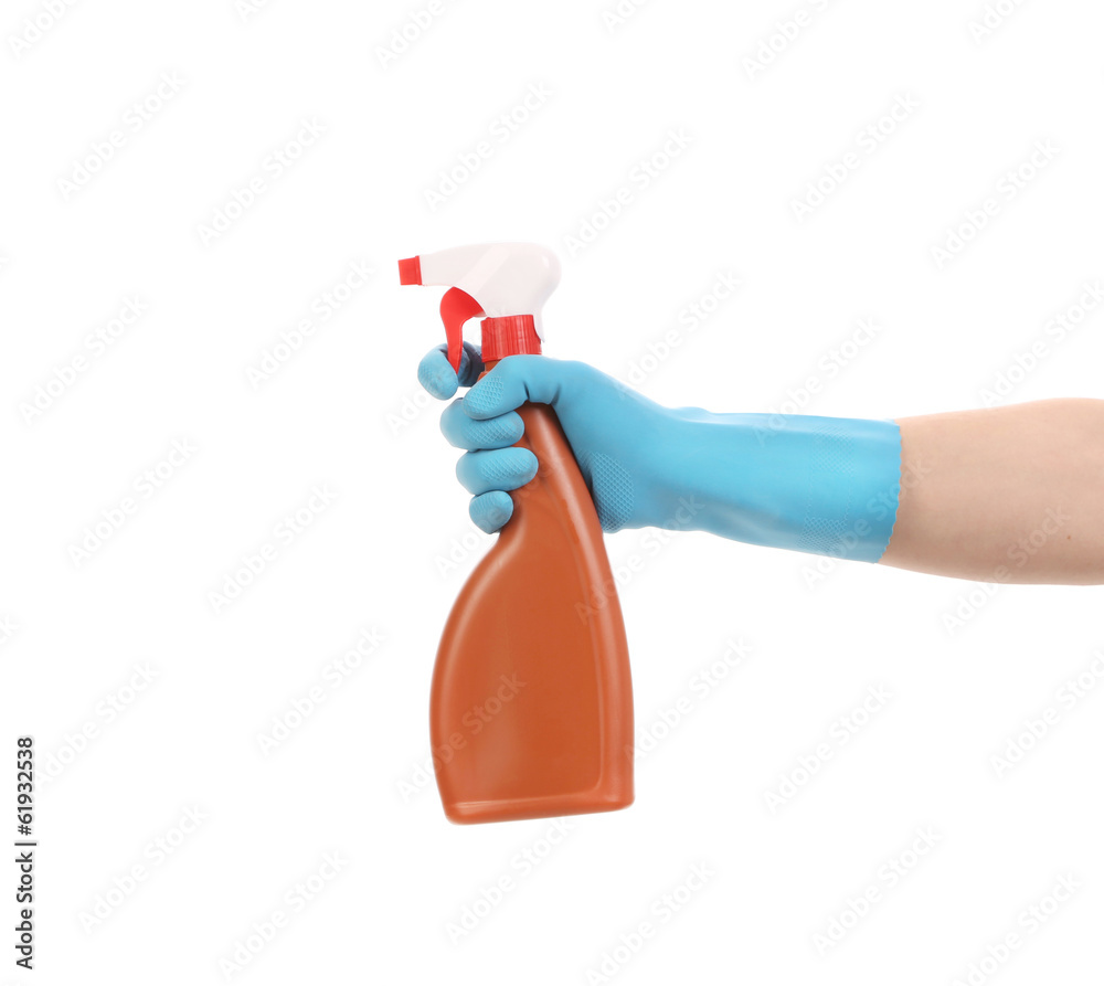 Hand in glove holding brown plastic spray bottle. Hand in glove holding brown plastic spray bottle.