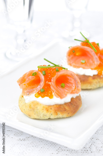 potato bun with salted salmon, red caviar and chives, vertical