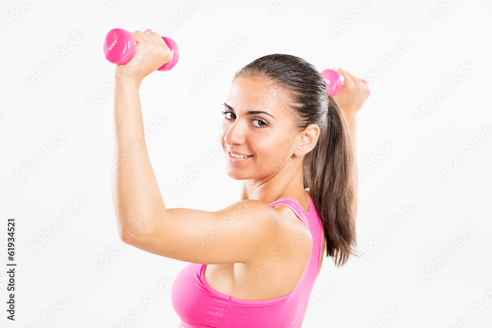 Beautiful woman exercising with dumbbells. Beautiful woman exercising with dumbbells.