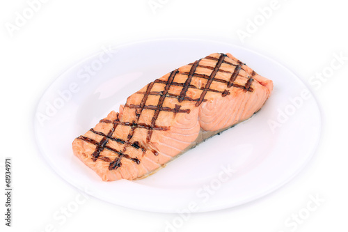 Fried salmon fillet on plate.