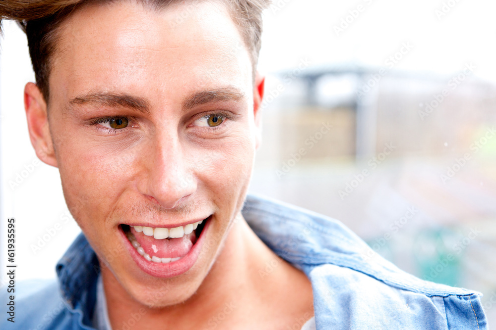 Close up portrait young man laughing Close up portrait young man laughing