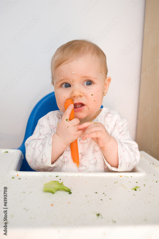 baby eating carrots at home, all soiled vegetables, healthy nutr baby eating carrots at home, all soiled vegetables, healthy nutr