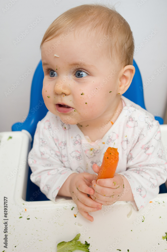 baby eating carrots at home, all soiled vegetables, healthy nutr baby eating carrots at home, all soiled vegetables, healthy nutr