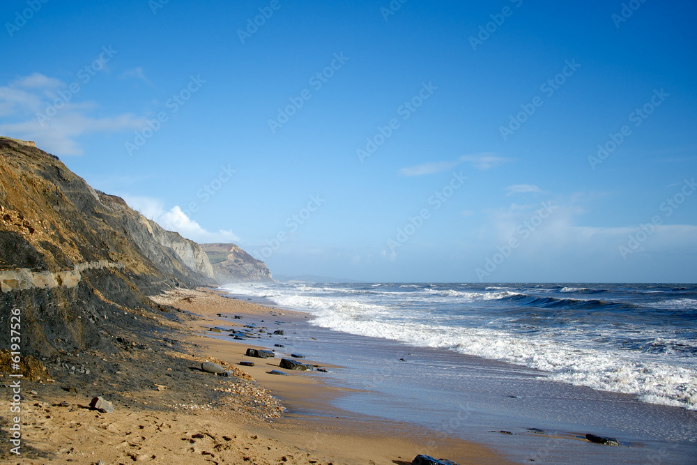 Charmouth beach rough sea and Golden Cap Dorset England