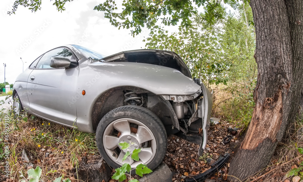 Road accident car crash againsta a tree on a city road