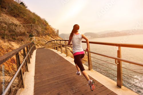 healthy lifestyle sports woman running on wooden bridge seaside  © lzf