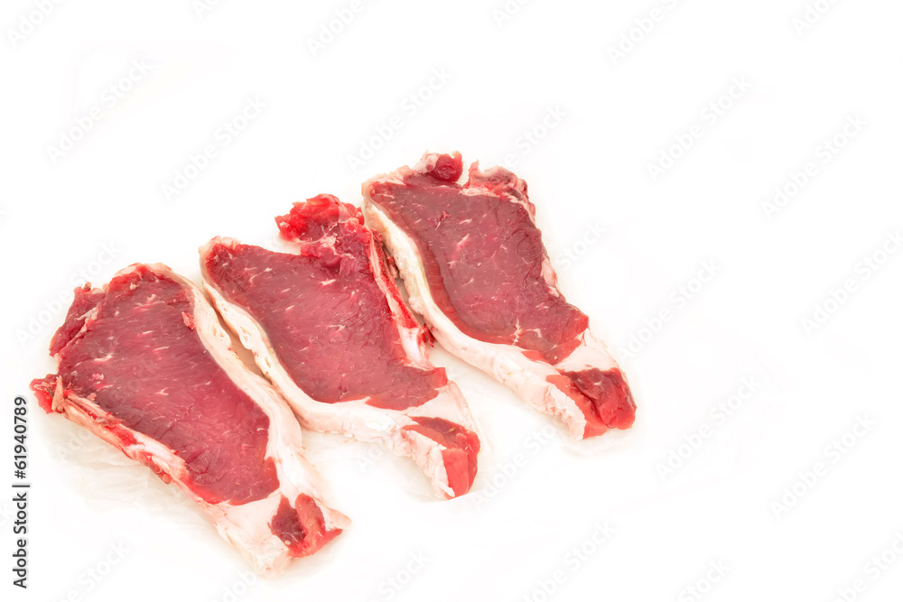 three Spanish beef steaks on paper isolated three Spanish beef steaks on paper isolated
