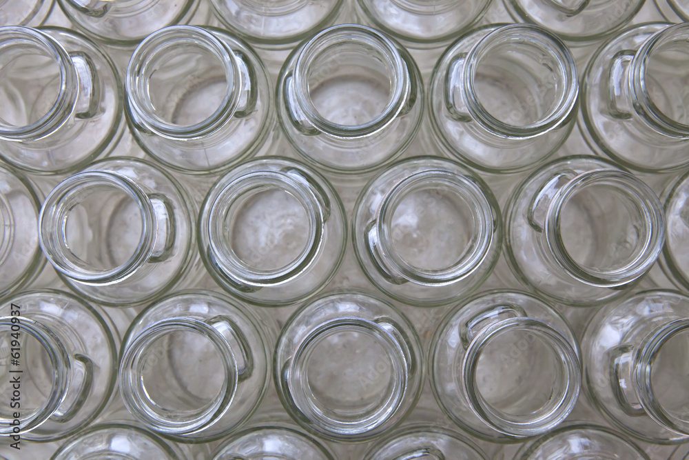 empty clear glass bottles in rows, top view
