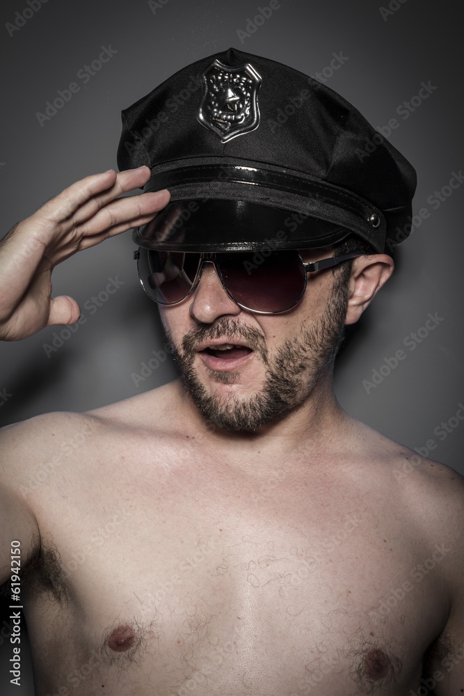 Good looking policeman, sexy police with sunglasses over dark ba Good looking policeman, sexy police with sunglasses over dark ba