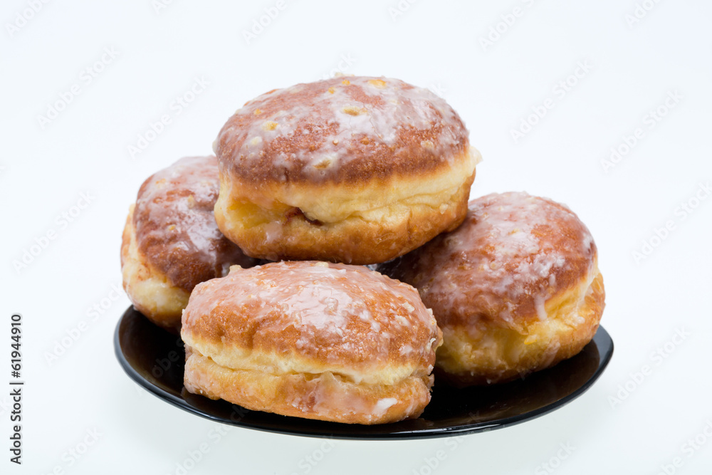 whole donuts on the black porcelain plate