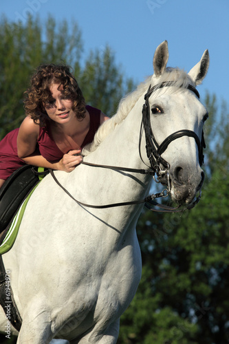 Girl laying relaxed bareback on her horse