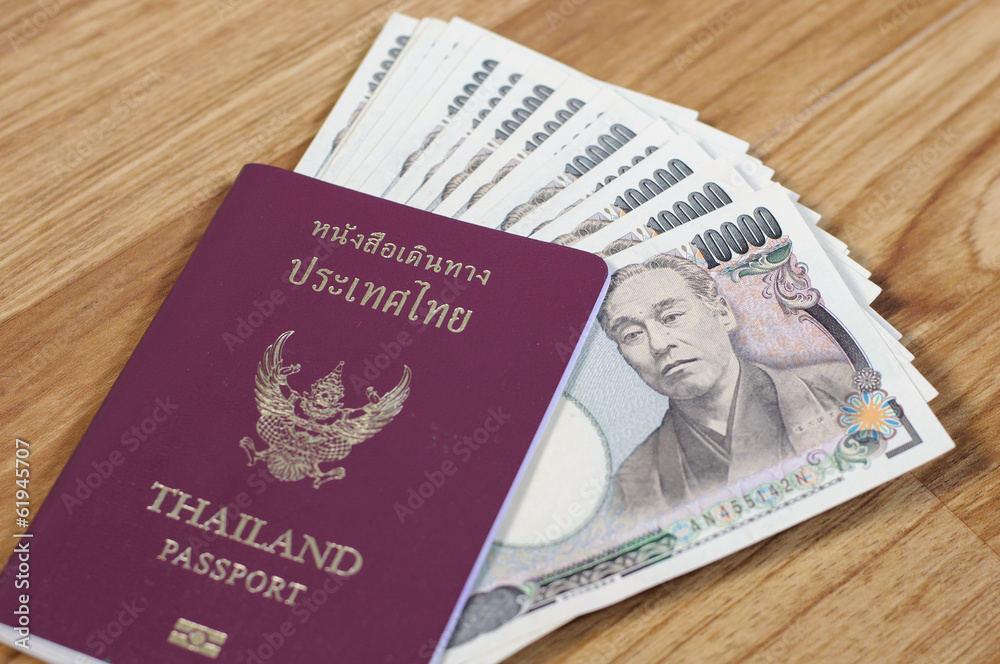 Fototapeta premium Japanese banknotes and Thailand passport
