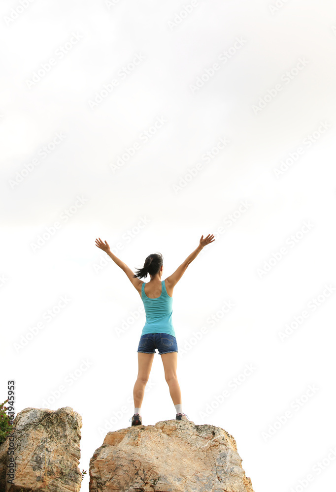 woman hiker cheering seaside mountain peak rock woman hiker cheering seaside mountain peak rock